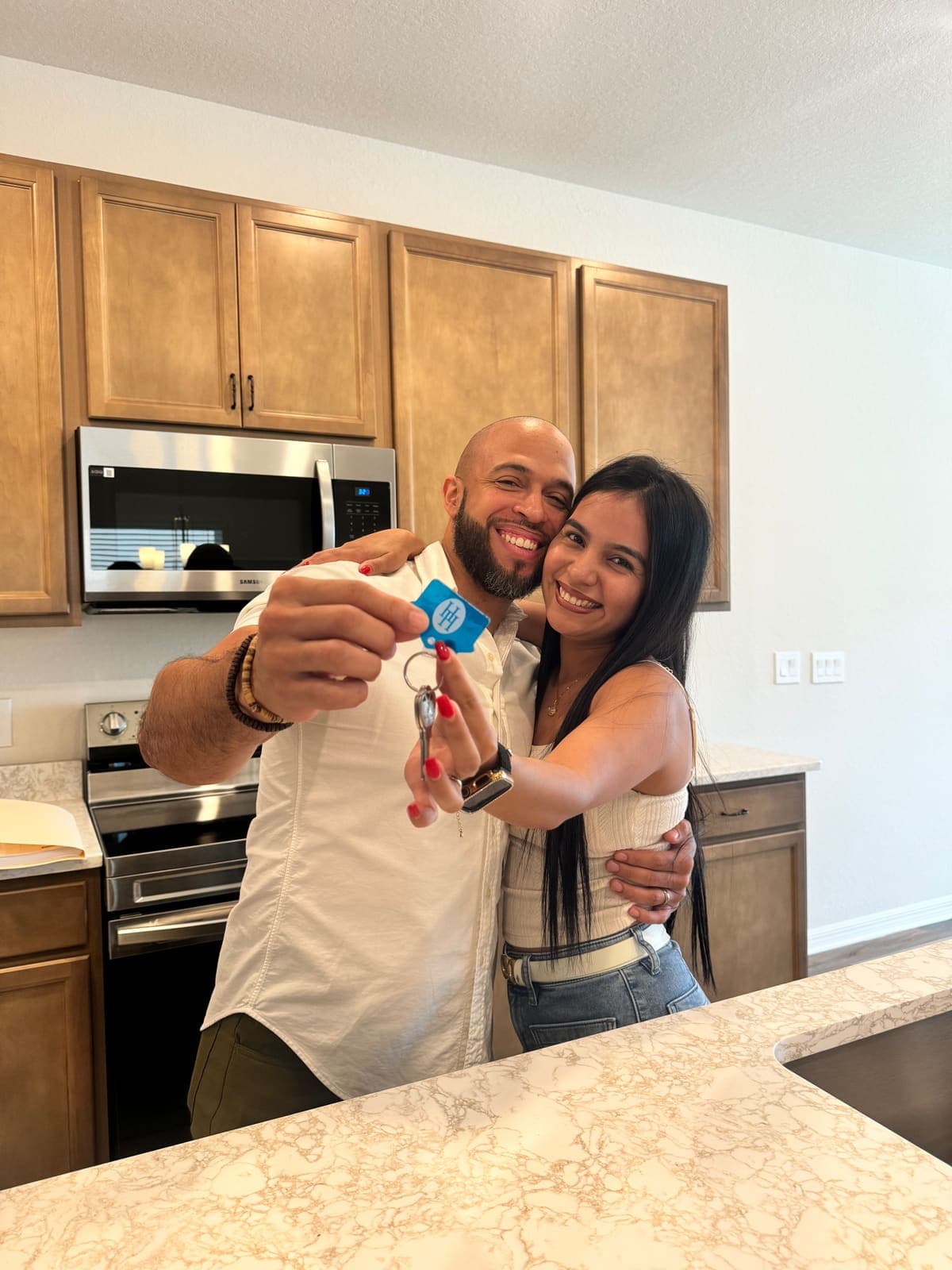 Buyers celebrating with the keys to their new home