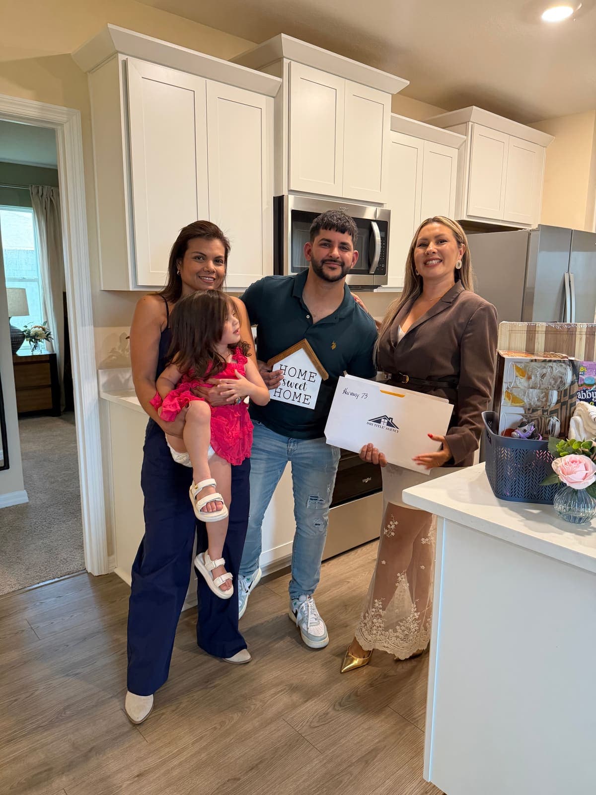 Buyers with their keys and closing gift from Jenny Caso
