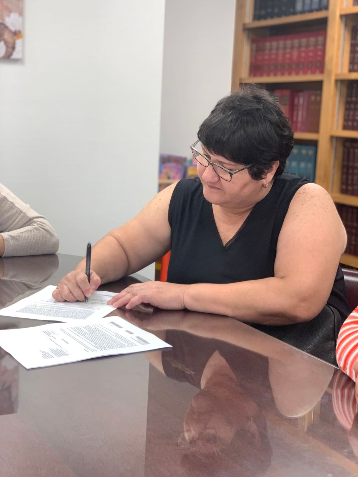 A client signing closing documents on their Central Florida home purchase