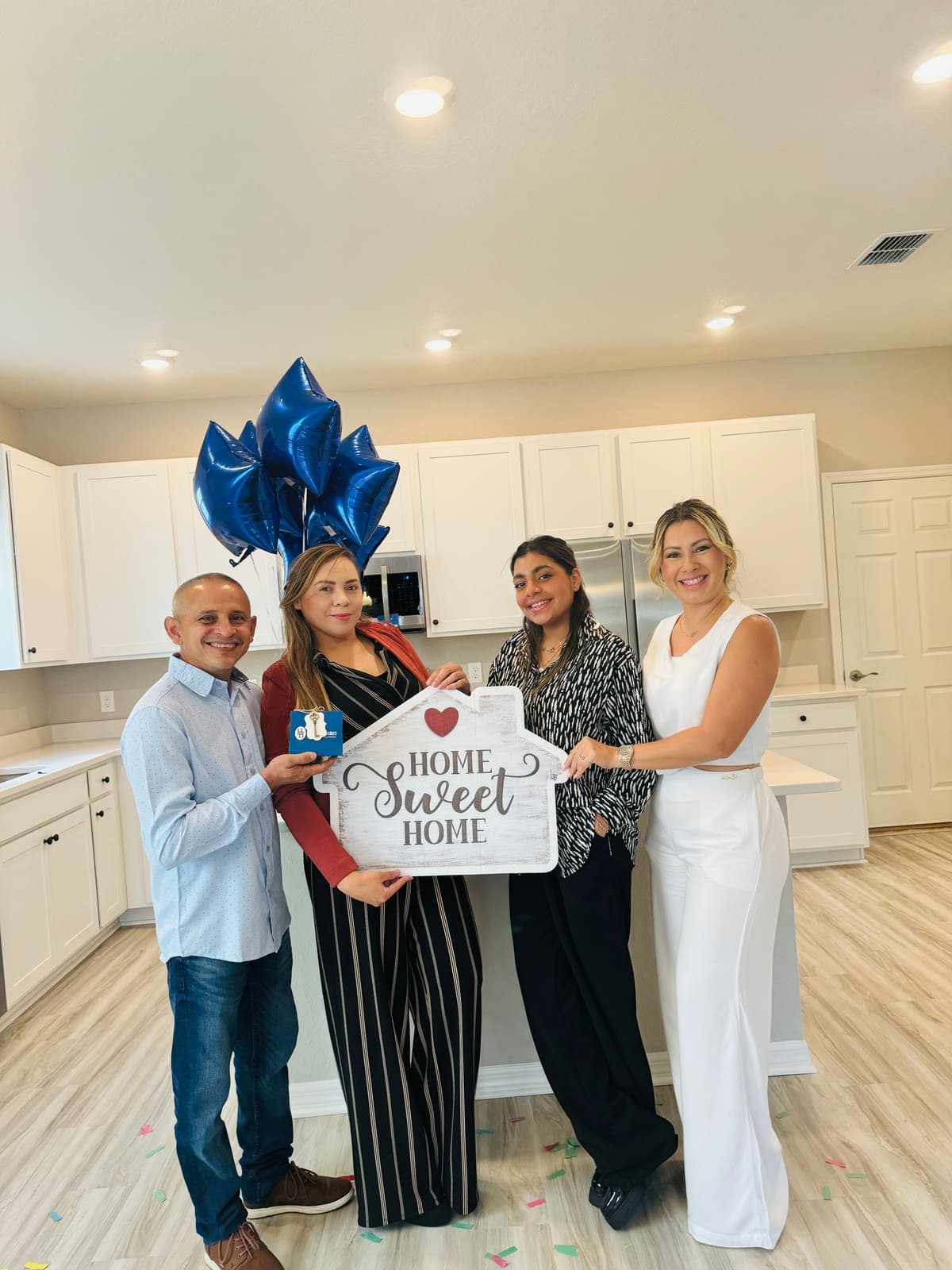 A family celebrating with a Home Sweet Home sign in their new Central Florida home