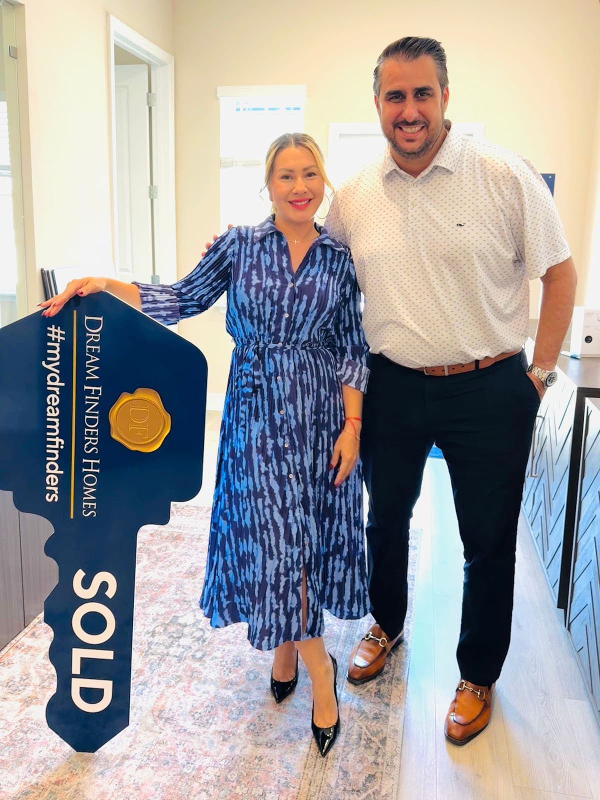Buyers with the sold sign at their newly built Central Florida home